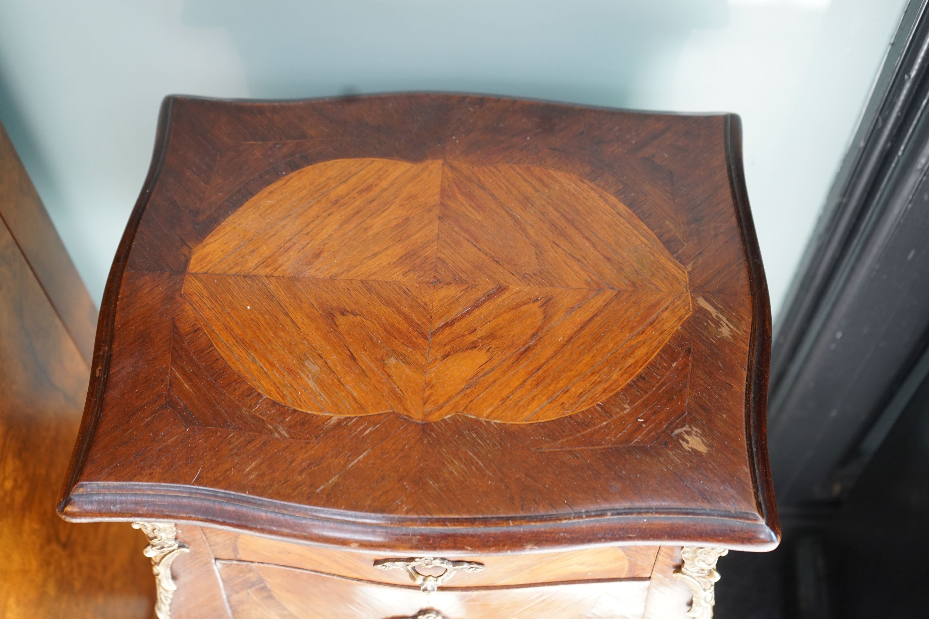 A pair of Louis XVI style serpentine kingwood two drawer bedside chests, width 34cm, depth 26cm, height 78cm